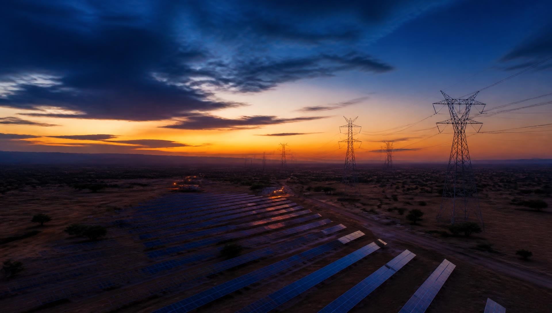 Utility-scale solar generation and transmission infrastructure at dusk